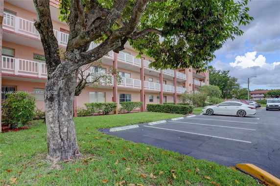 Front view of a multi-story residential building with balconies.