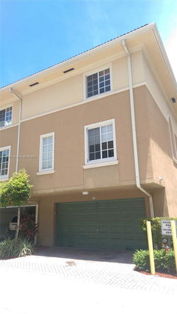Front view of a multi-story building with a garage entrance.