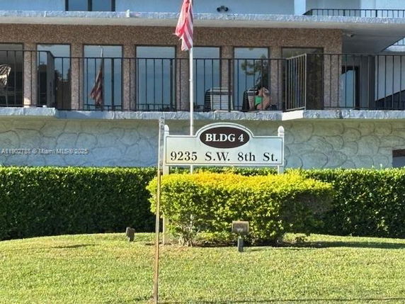 Front view of a building with balconies and windows.