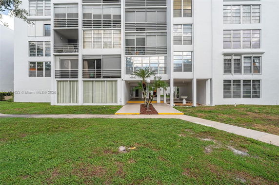 Front view of a multi-story building with a covered entrance.