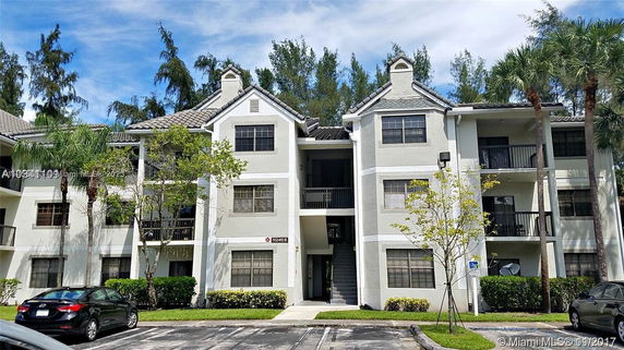 Front view of a multi-story residential building with balconies