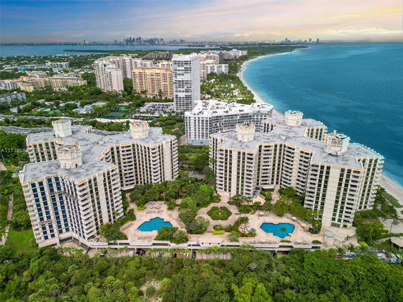 Aerial view of a large beachfront condominium complex near the ocean.