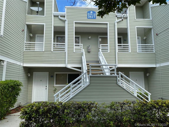 Front view of a multi-story building with staircases and balconies.