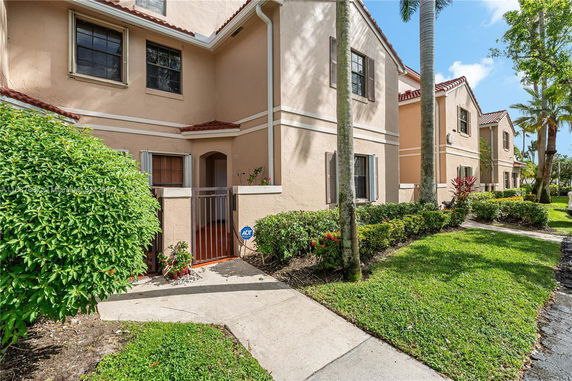 Front view of a two-story house with a gated entrance.