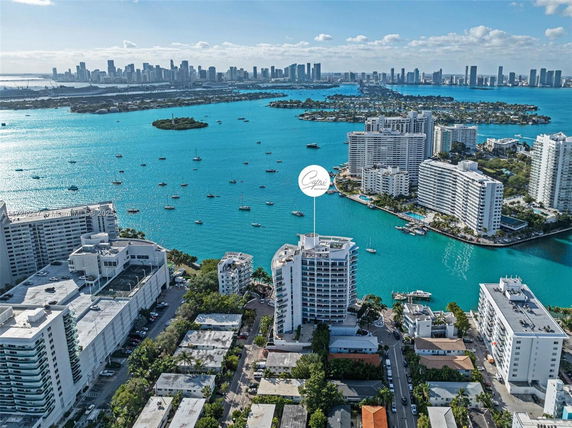 Panoramic view of a cityscape with high-rise buildings and a waterway.