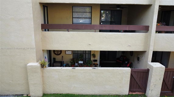 Front view of a multi-story building with balconies and textured walls.