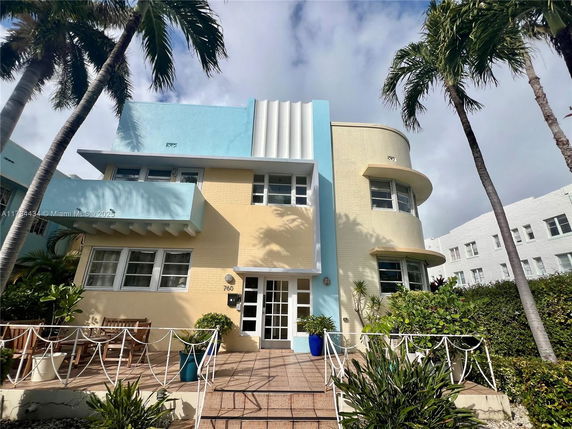 Front view of a modern two-story building with blue and beige accents.