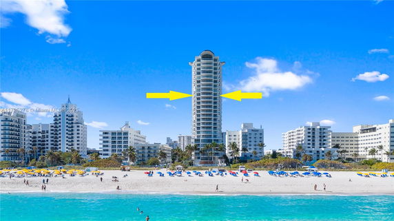 View of a tall residential building facing the beach.