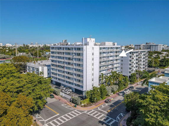 Front view of a multi-story apartment building with balconies.