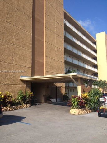 Front view of a multi-story building with a covered entrance.
