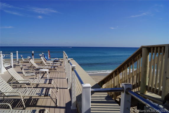 Outdoor deck with lounge chairs overlooking the ocean.