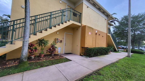 Side view of a two-story building with external staircase.