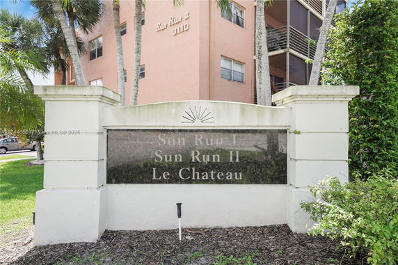 Front view of a multi-story residential building with signage.