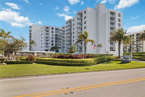 Front view of a multi-story residential building with balconies.