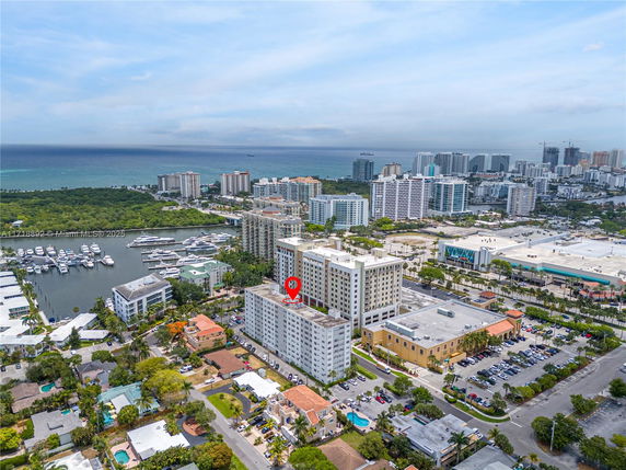 Aerial view of a coastal city with high-rise buildings and a marina.