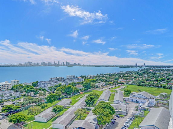 Panoramic view of city skyline and waterfront buildings.