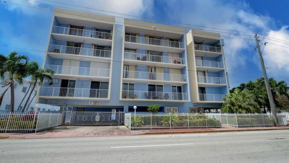 Front view of a multi-story residential building with balconies.