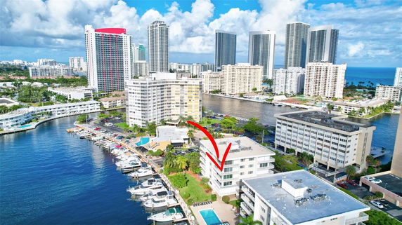 Aerial view of a waterfront area with multiple residential high-rise buildings.