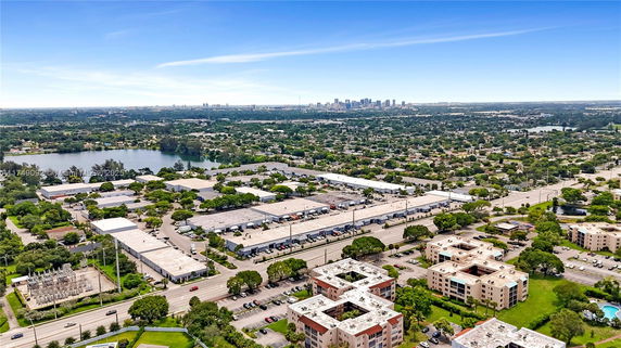 Panoramic view of urban area with multiple buildings and city skyline in the distance.