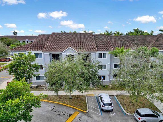 Front view of a three-story residential building with a tiled roof.