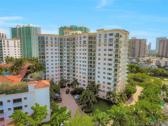 Front view of a multi-story apartment building with balconies.