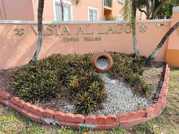 Front view of a condo complex entrance with signage 'Vista Al Lago'.