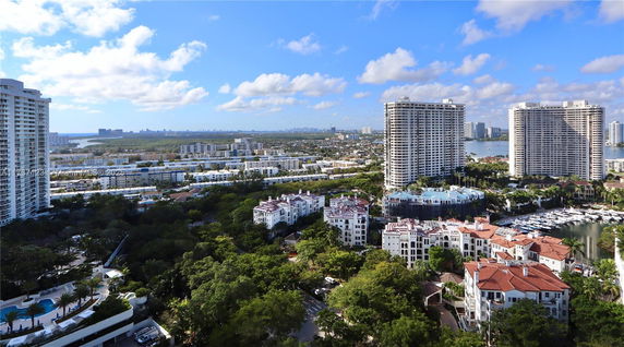 Panoramic view of urban cityscape with high-rise buildings and waterfront.