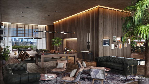 Interior of a modern club house with pool table and seating area.