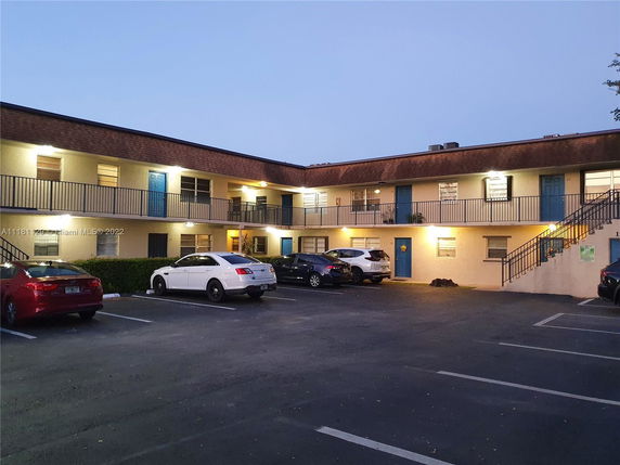 Two-story building with parking area in front