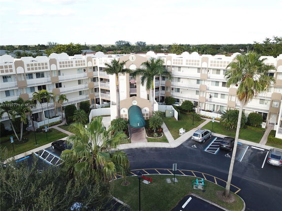 Front view of a multi-story residential building with balconies.