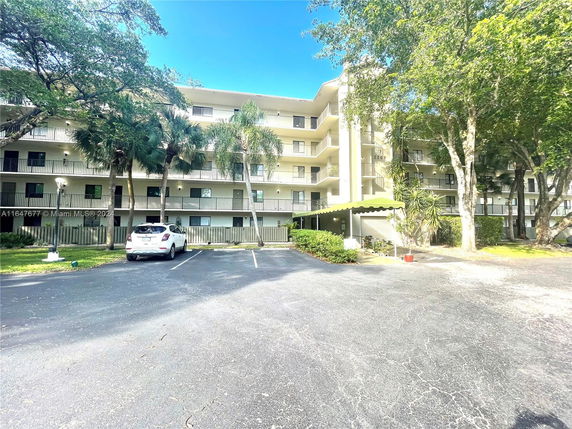 Front view of a multi-story residential building with balconies.