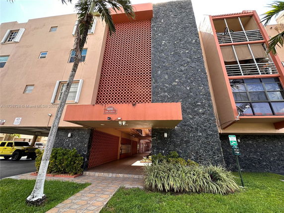 Front view of a multi-story building with a textured exterior.