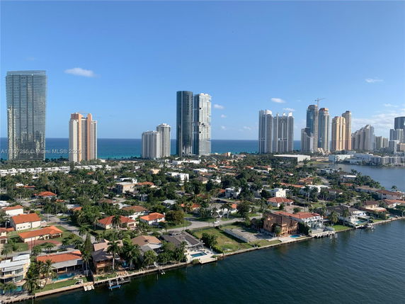 Panoramic view of a cityscape featuring high-rise buildings by the coastline.