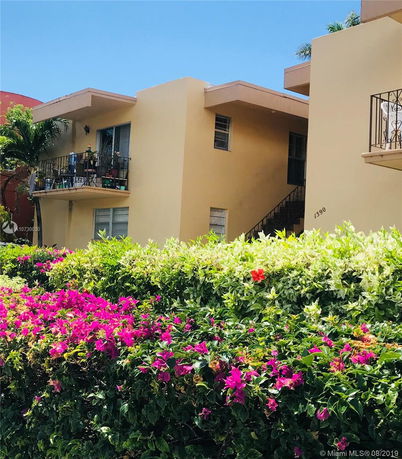 Front view of a two-story building with balconies.