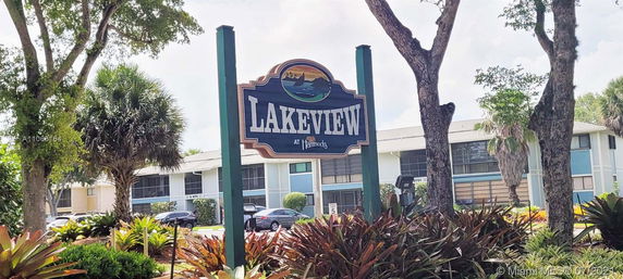 Front view of a multi-story residential building with a 'Lakeview at Hammocks' sign.