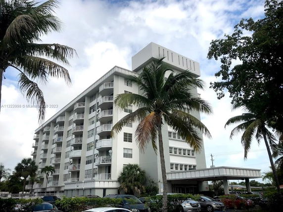 Front view of a multi-story residential building with balconies.