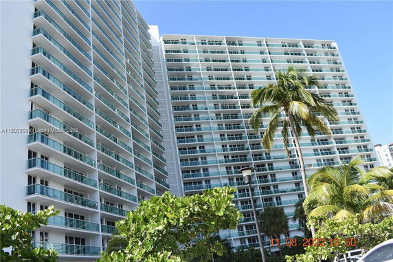Front view of a high-rise apartment building with multiple balconies.