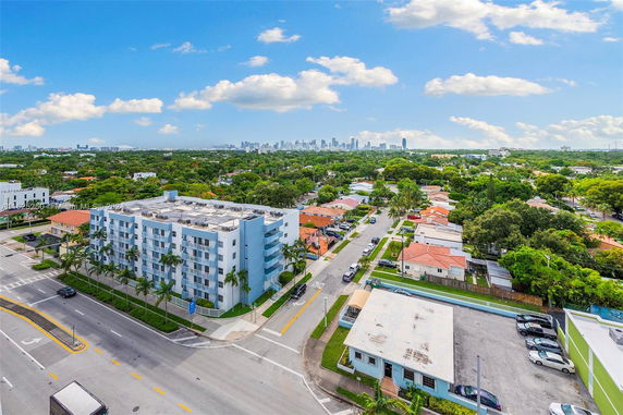 Panoramic view of a city skyline with a residential area and streets in the foreground.