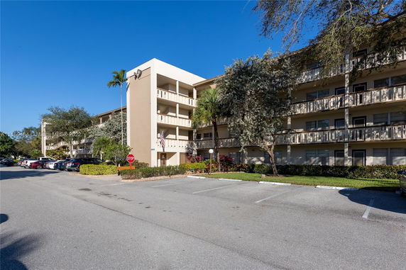 Front view of a multi-story apartment building with balconies.