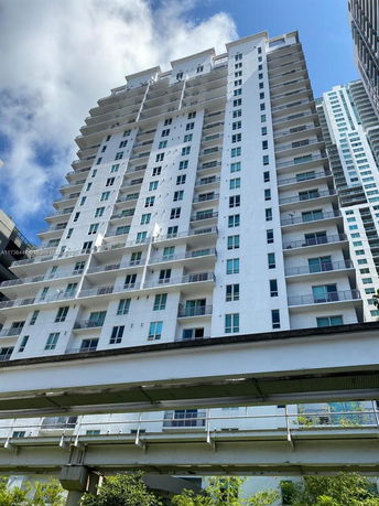 Front view of a multi-story residential building with multiple balconies.