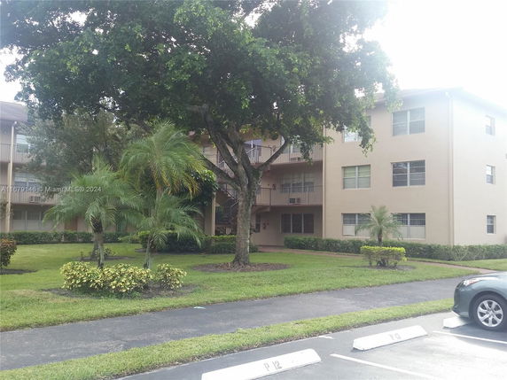 Front view of a multi-story residential building with balconies.
