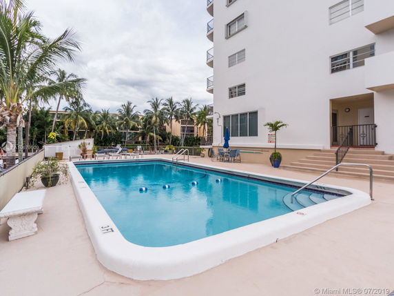 View of a multi-story building next to a swimming pool.