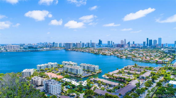 Panoramic view of city skyline with water bodies and residential areas.