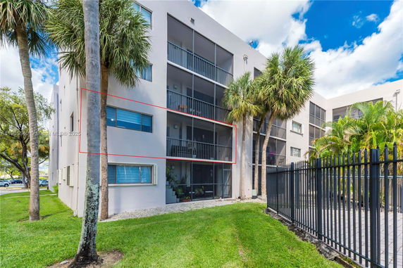 Front view of a multi-story apartment building with balconies.