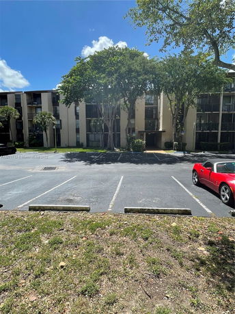Front view of an apartment building with multiple floors and balconies.