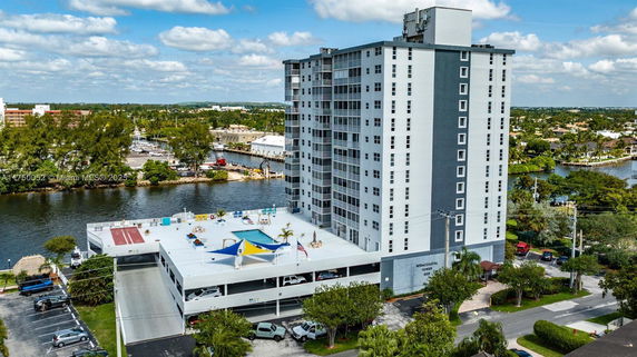 Front view of a multi-story building overlooking a waterway.