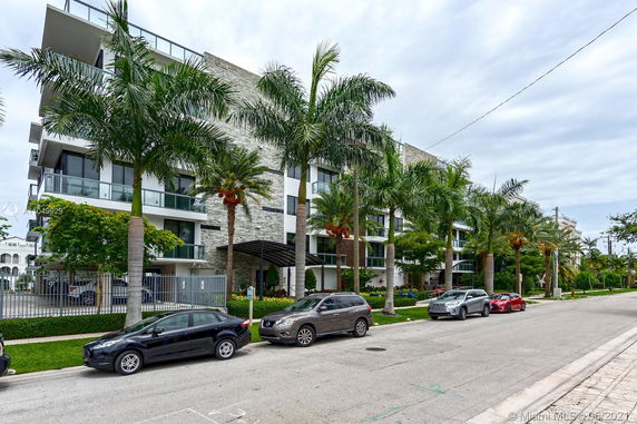 Front view of a multi-story condominium building with balconies.