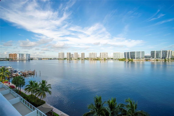 Panoramic view of a waterfront area with high-rise buildings in the distance.