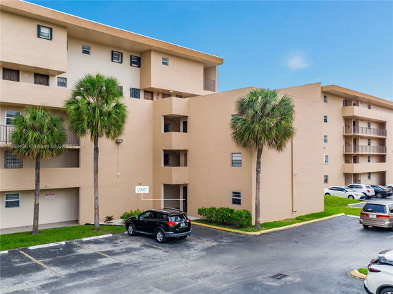 Front view of an apartment building with multiple floors and balconies.