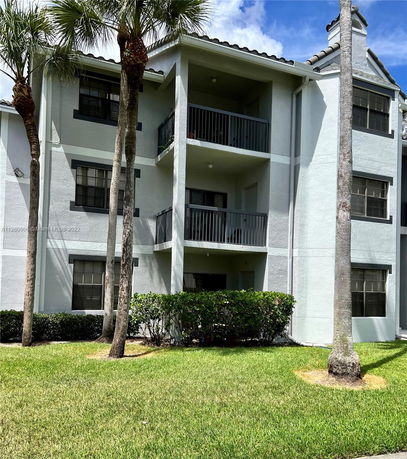 Front view of a three-story residential building with balconies.